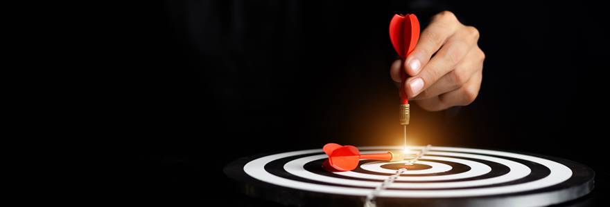Businessman,Holding,A,Darts,Aiming,At,The,Target,Center,Business