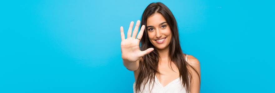 Young,Woman,Over,Isolated,Blue,Background,Counting,Five,With,Fingers