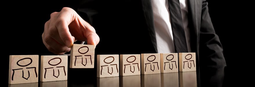 Businessman,In,Black,And,White,Business,Suit,Arranging,Wooden,Pieces