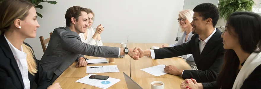 Diverse,Businessmen,Shaking,Hands,After,Signing,Contracts,At,Group,Multiracial