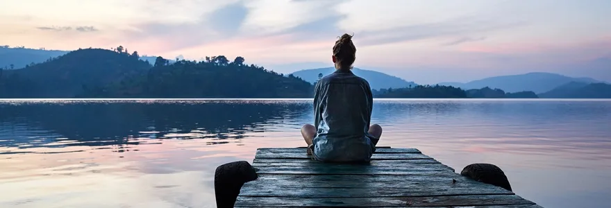 Peaceful,Lifestyle,Shot,Of,Woman,Sitting,On,Dock,At,Sunset