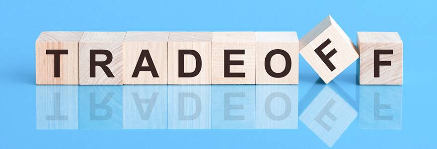 Text,Tradeoff,On,Wood,Cube,Block,,Stock,Investment,Concept.,The