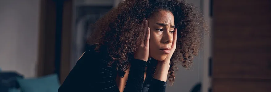 Low-spirited female leaning her elbows on her knees